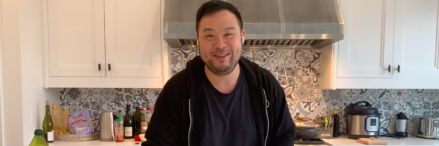 Chef David Chang stands in front of a kitchen counter with a bowl full of rising dough