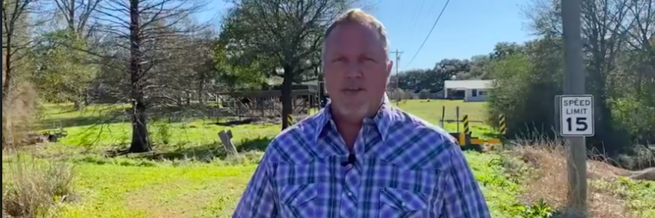 Rob Anderson's Louisiana Campaign for Congress Is One to Watch Rob Anderson, an older man wearing a short-sleeve plaid shirt standing on a country Louisiana road