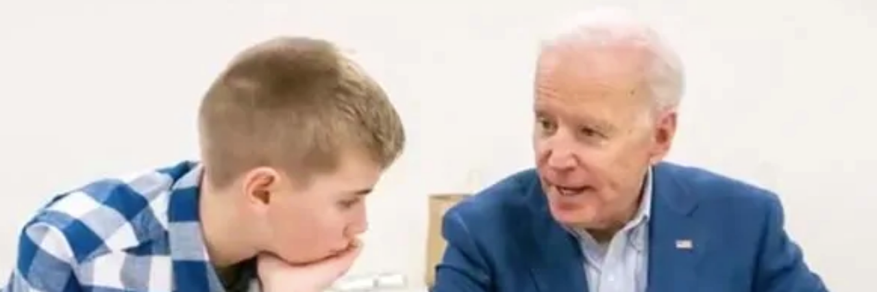 Joe Biden showing Braydon Harrington a book.