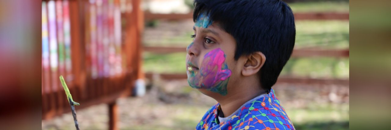 How a Blue Tunic Taught Me to Listen to My Son With Autism Tulika's son at a festival holding incense.