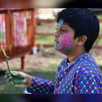 Tulika's son at a festival holding incense.