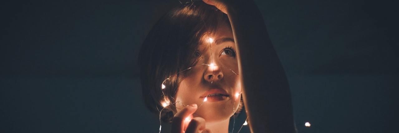 How "Examining the Data" Helps Manage My Anxiety Woman holding a tangle string of lights