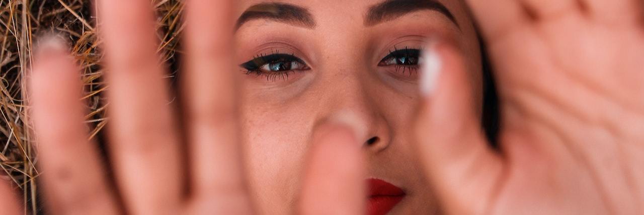 Dior Vargas: My Experience in the Psychiatric Hospital A woman lying down with her hands raised above her race