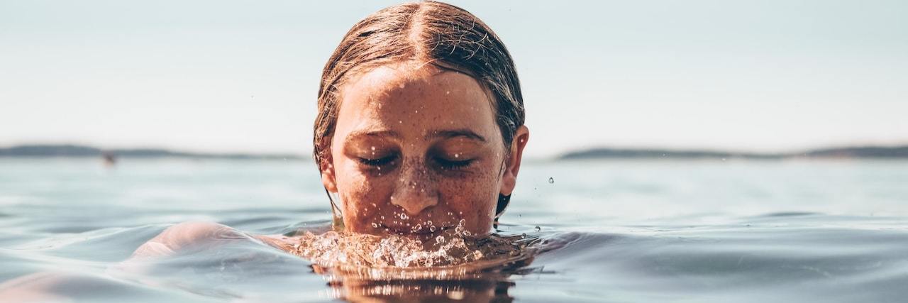 Woman's face coming up out of water