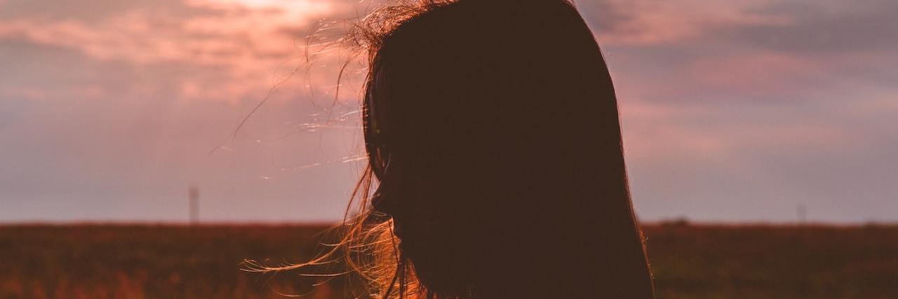 Experiencing Grief for Someone You Never Met, But Should Have Silhouette of woman in field at sunset