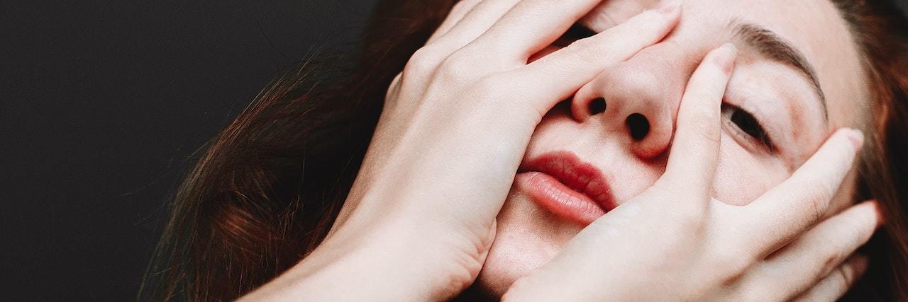 5 Ways People Experience Internalized Mental Health Stigma A woman with her head on her hands