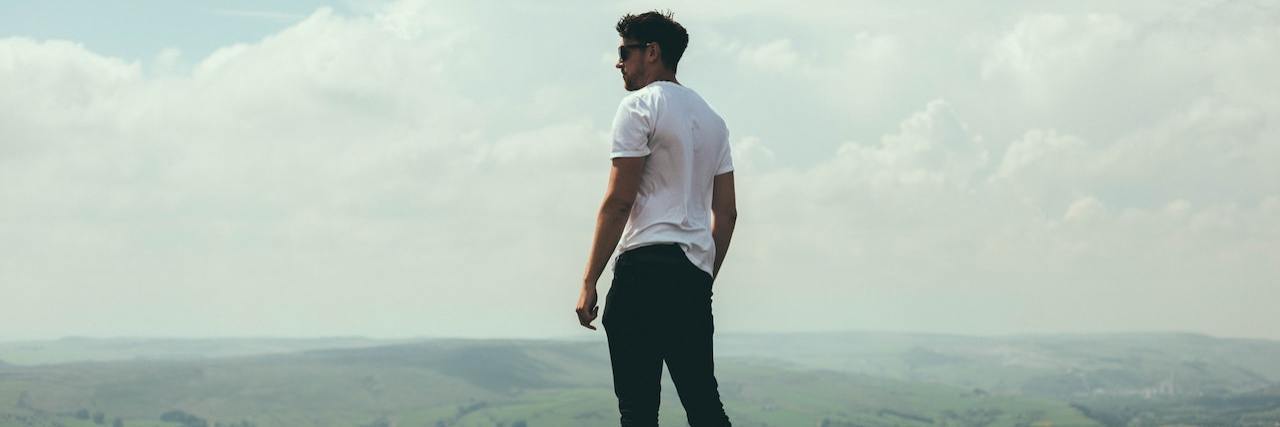 My Anxiety Is My Strength, Not My Weakness Man standing overlooking hills and mountains