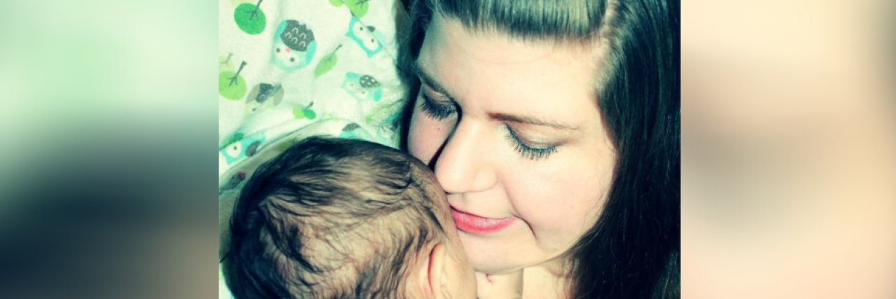 Developing PTSD From Parenting a Medically Fragile Child Contributor holding baby close with her eyes closed
