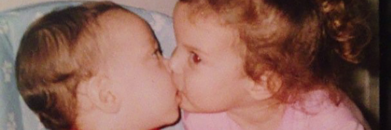 Community Support for Typical Siblings of Kids With Disabilities Abby as a small child, giving her brother a kiss.