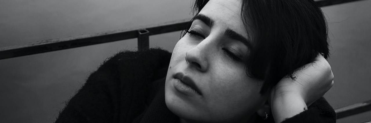 12 Unexpected Ways People Experience Grief a black and white portrait of a woman by a lake