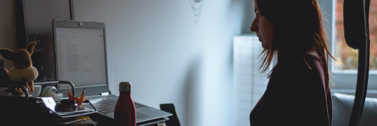 I Was Diagnosed With COVID-19 in Eating Disorder Recovery photo of woman sitting in chair in front of computer
