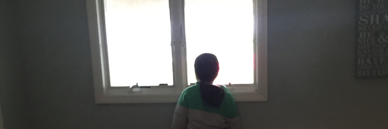 James' son looking out a window.