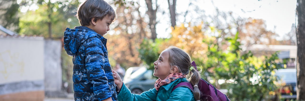 Letter to Sibling Caregivers of a Child With a Disability Big sister taking care of her little brother.