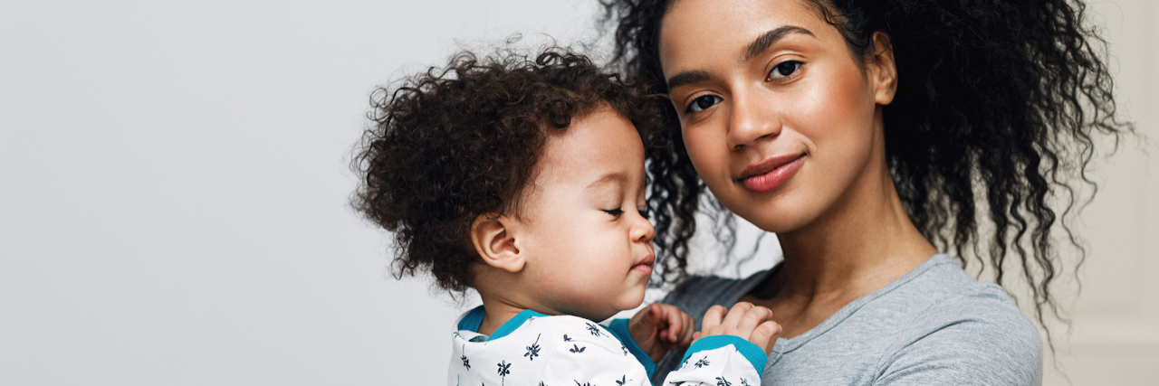 5 Things You Should Know About Phenylketonuria Young mom holding her sleepy baby boy