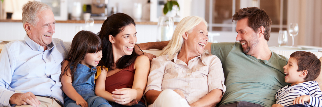 5 Lessons Chronic Illness Taught Me About Parenting Grown Children Happy three generation family sitting on a sofa at home.