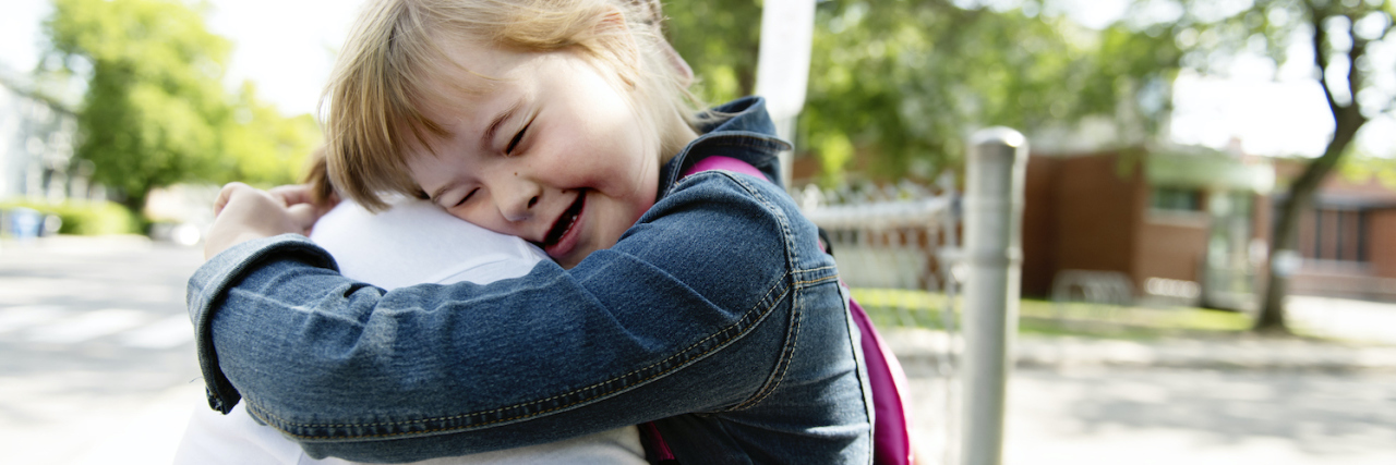 15 Comments That Hurt People With Down Syndrome A child with Down syndrome hugging her mom