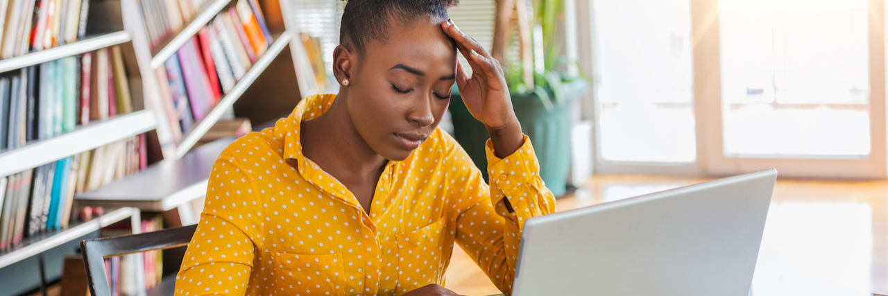 Study: Racial Bias Impacts Mental Health Care for Black Community Young frustrated woman working at office desk in front of laptop