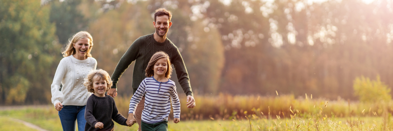 Mindfulness and Parenting Kids With Disabilities During COVID-19 Young family having fun outdoors.