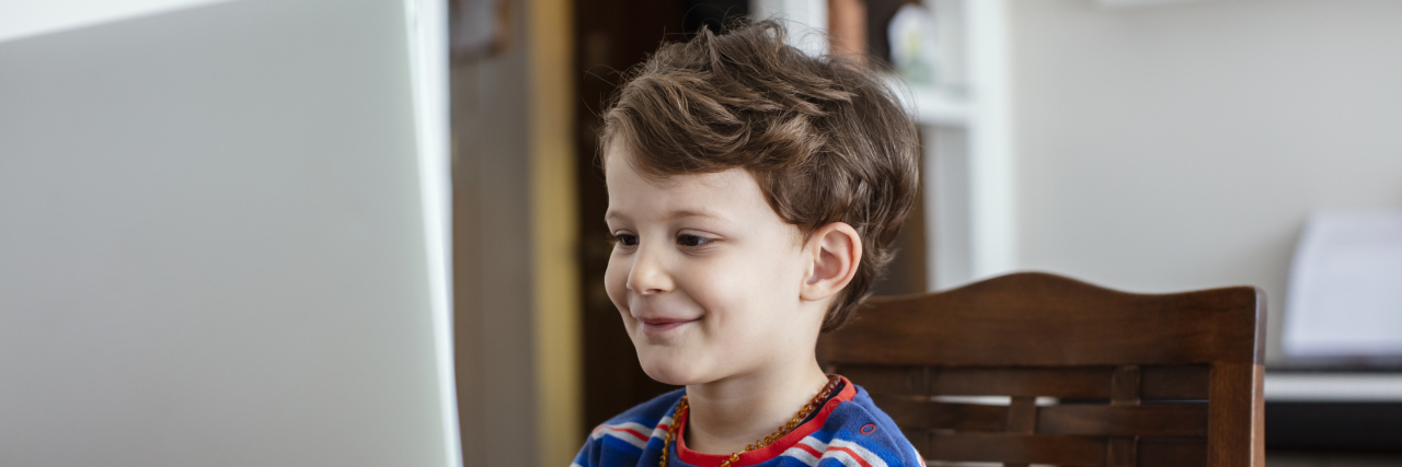 Boy attending school online.