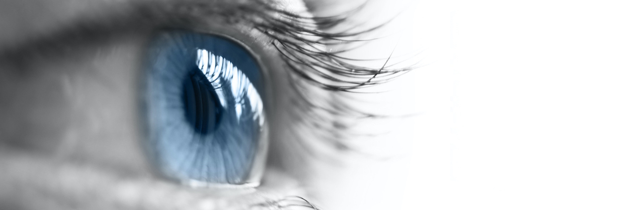 The Good I'm Trying to Find Even as I Lose My Eyesight Close up of a blue eye over the reflection of water