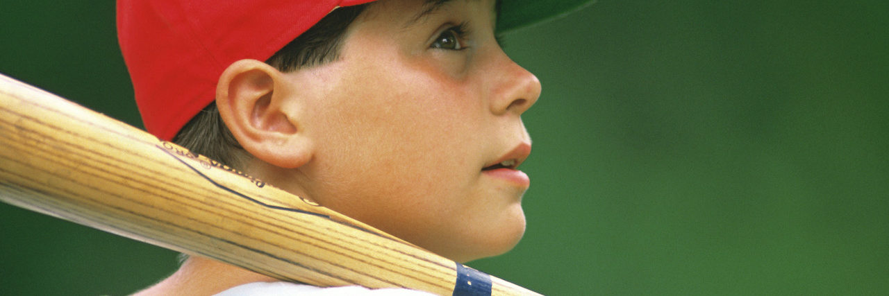What It's Like Having a Panic Attack as a 12-Year-Old A young boy in a red hat holding a baseball bat
