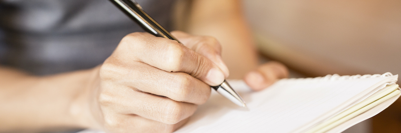 A Letter to Myself When I Feel Like Life Isn’t Worth Living Women holding a pens writing a notebook.