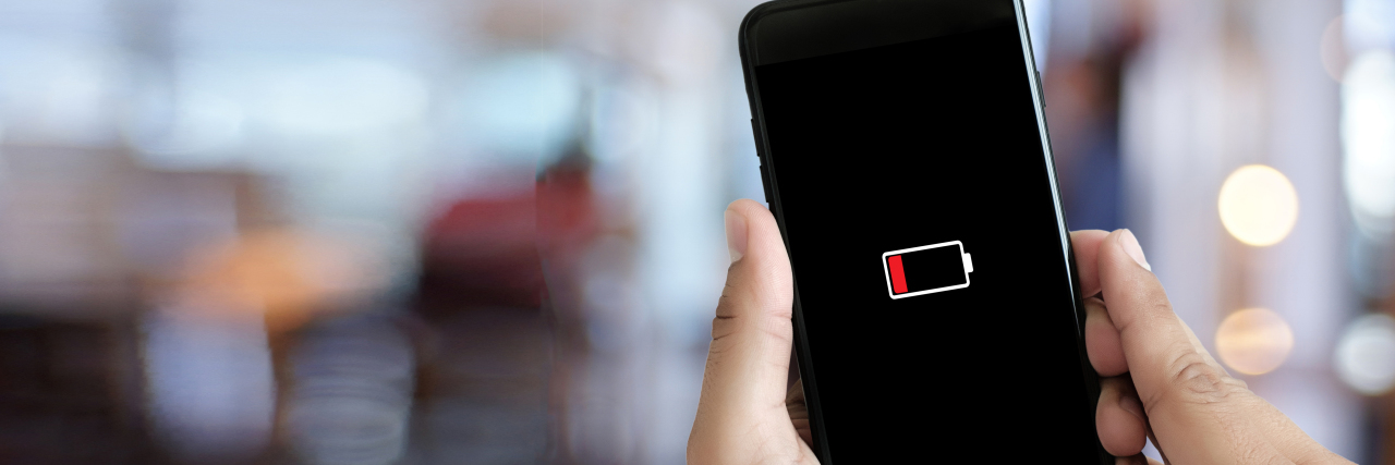 What My Cell Phone Taught Me About Managing Chronic Migraine Smart phone with low battery.
