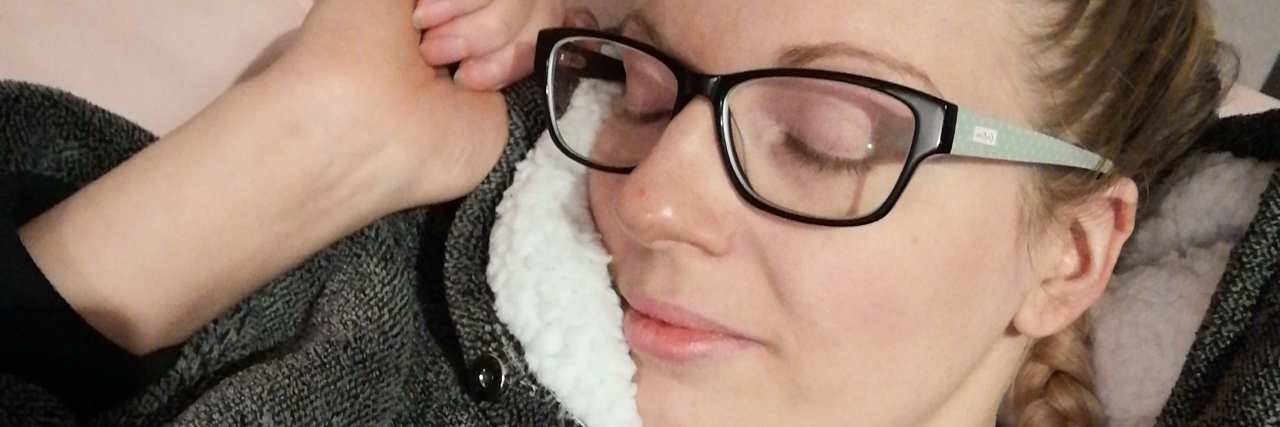 To COVID 'Long Haulers,' From Someone With Chronic Fatigue the author in a blanket with her eyes closed