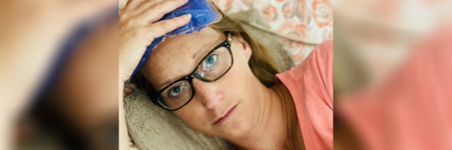 photo of contributor lying down, looking unhappy with an ice pack on her head