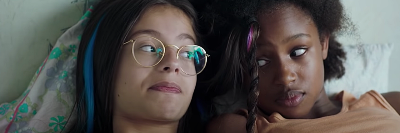 A Sexual Abuse Survivor Reviews the Netflix Film 'Cuties' image from Cuties, two girls laying next to each other