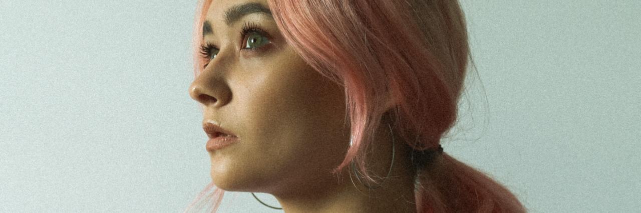 Read This If You're Suicidal Because of Fibromyalgia Pain photo of woman with pink hair looking off to the distance