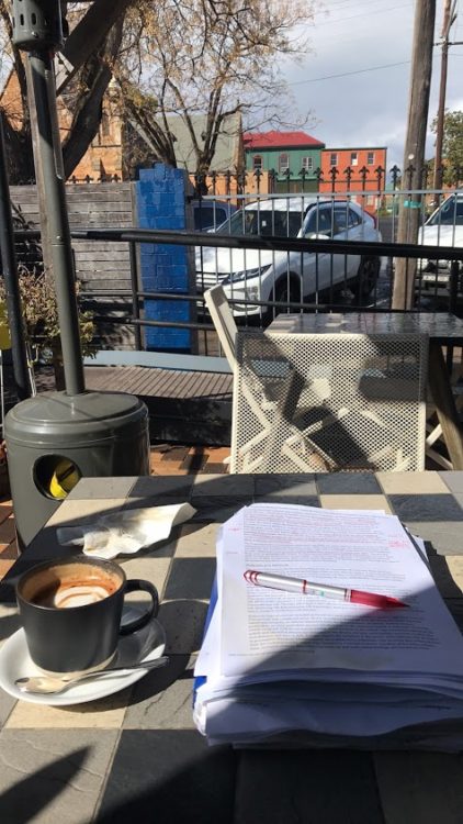 Photo from contributor of paper and pen at outdoor cafe