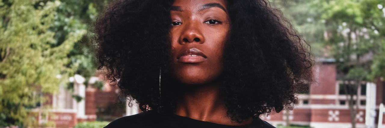 A Black Woman's Response to Rheeda Walker on Mental Health and Suicide photo of Black woman staring into camera with serious expression