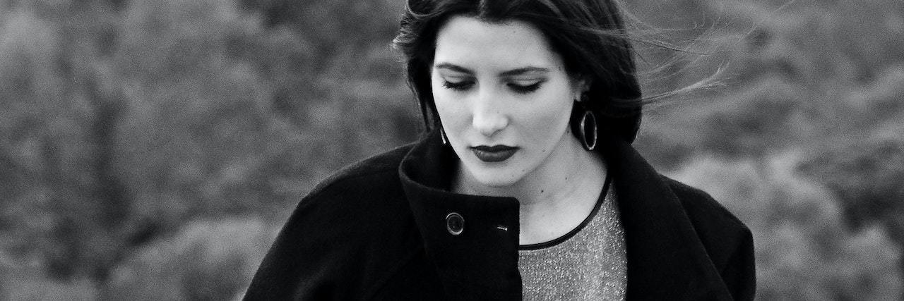 It's OK to Feel Mixed Emotions When an Abuser Dies A woman looking down