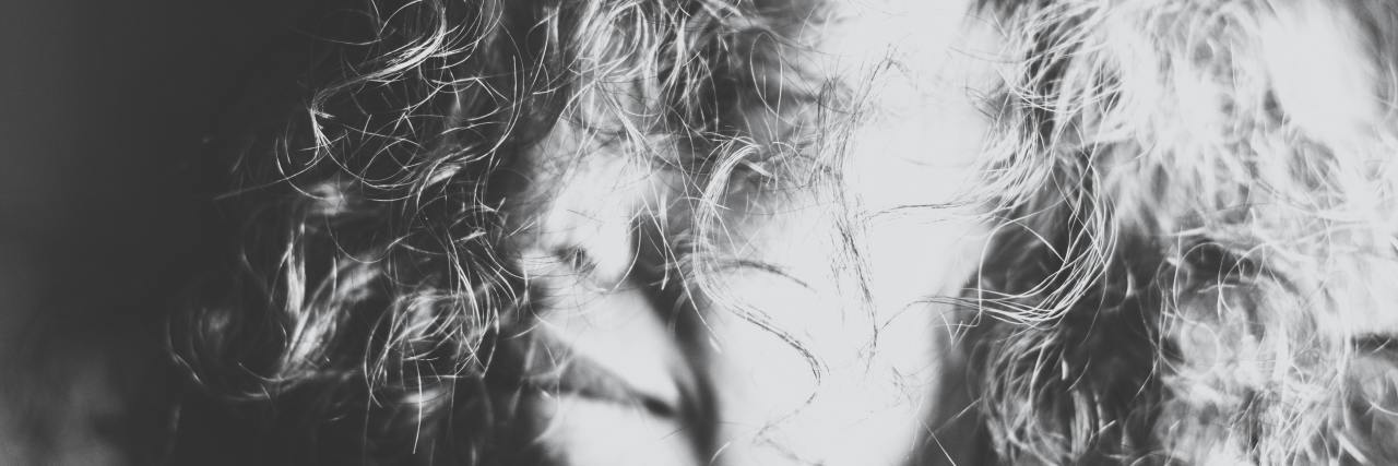 Why Not Having a Routine Helped With Depression During COVID-19 A person smiling in black and white
