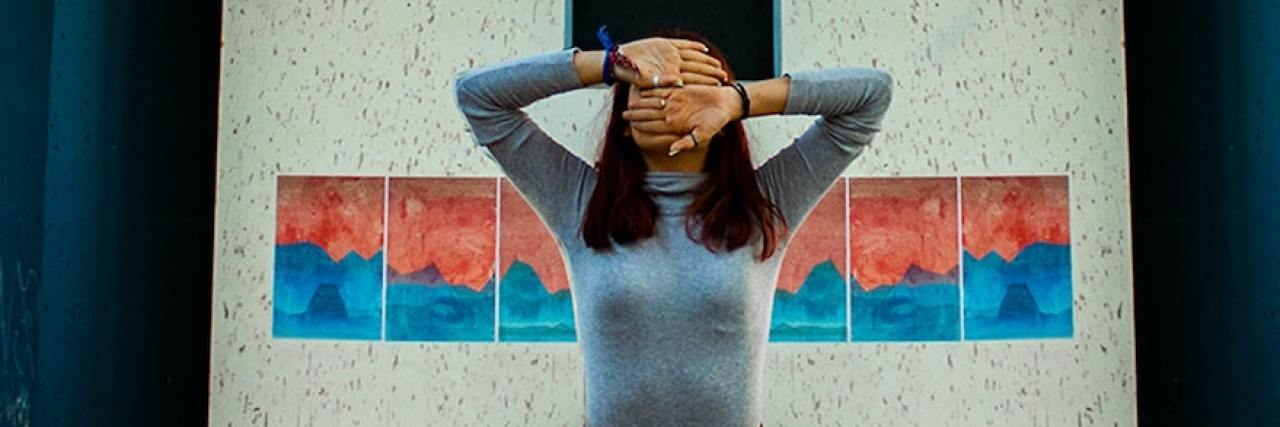 Is Living Through Depression and Anxiety Worth It? Woman with her hands covering her head