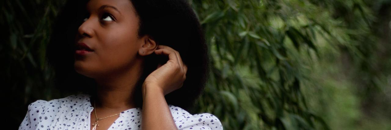 Experience: Pelvic Floor Physical Therapy as a Sexual Abuse Survivor photo of woman in a white dress standing under a tree, looking up at it