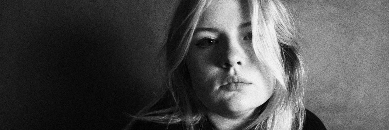 How To Cope After a Suicide Attempt in Your Teens black and white photo of teen woman looking into camera, sad