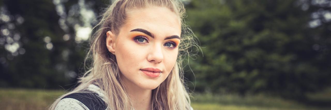 Suicide Prevention Month Campaigns Miss Smiling Suicidality photo of blonde woman looking into camera with serious expression