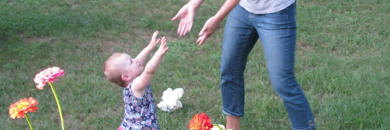 Jen and her daughter Emma playing outside.