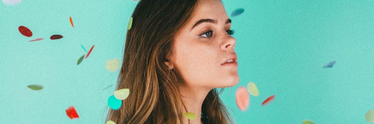 Living a Messy and Beautiful Life With Bipolar Disorder A woman with confetti falling on her head