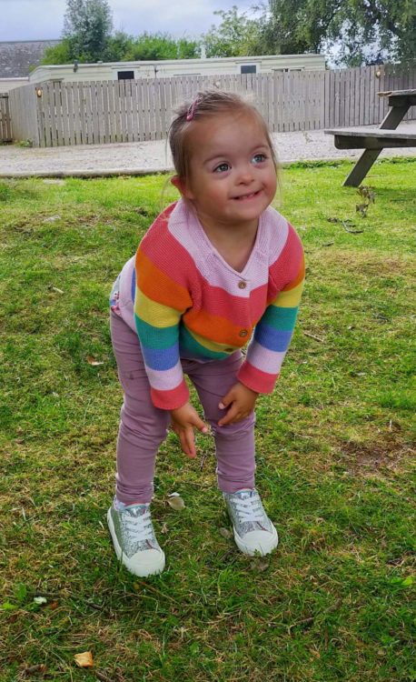 Rachel's daughter wearing a rainbow striped shirt.