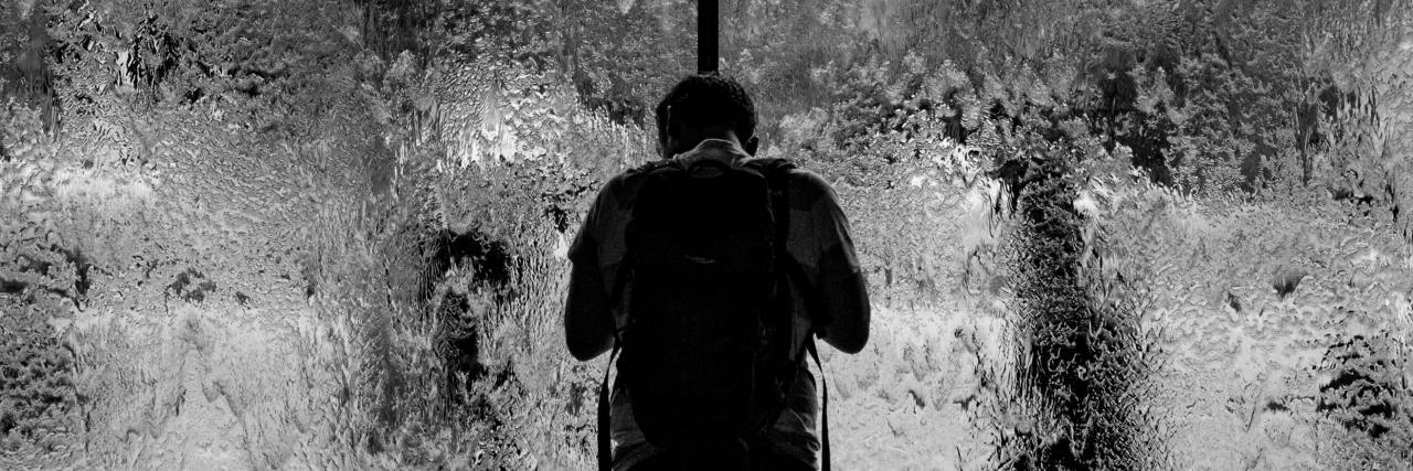 How Paranoia Affects Someone With Schizophrenia black and white photo of man in front of rainy glass window