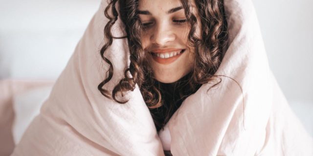 Woman cozy wrapped up in a blanket