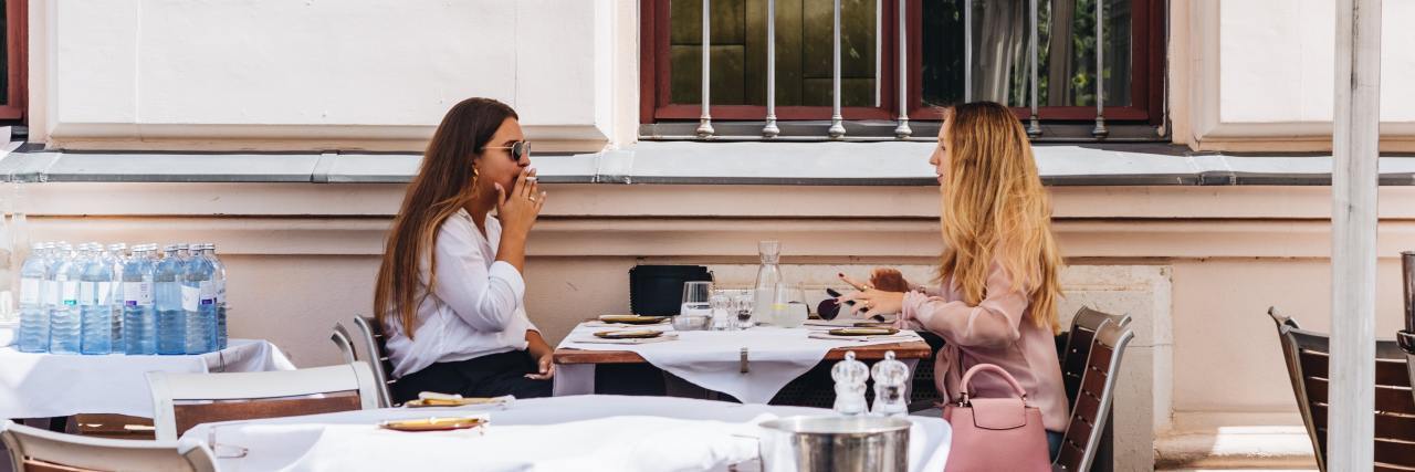 Telling My Friends About My Borderline Personality Disorder, Bipolar photo of two women talking over a table in a restairant