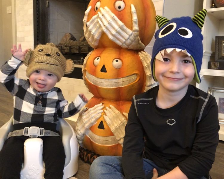 Ace and his brother with Halloween pumpkins.