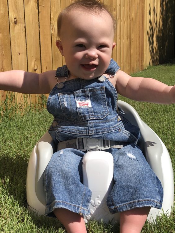 Ace sitting outside, holding his arms out.