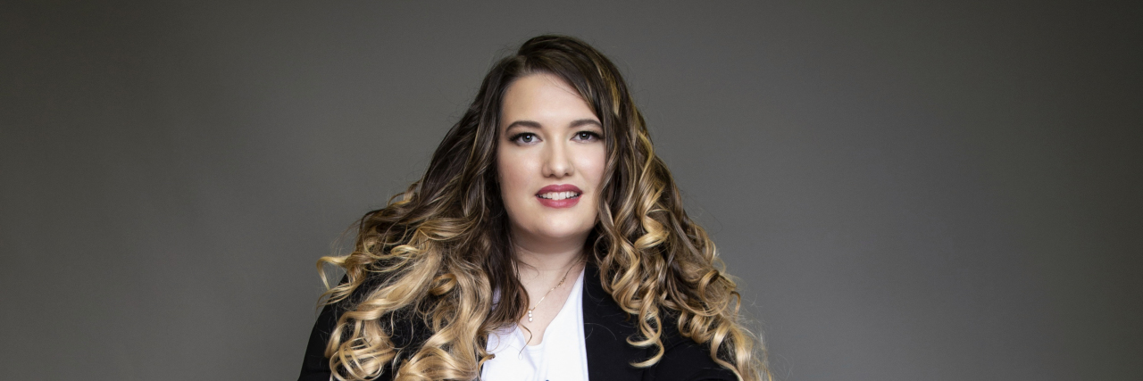 Entrepreneurship and National Disability Employment Awareness Month Erin wearing a long black skirt, white blouse and black jacket.
