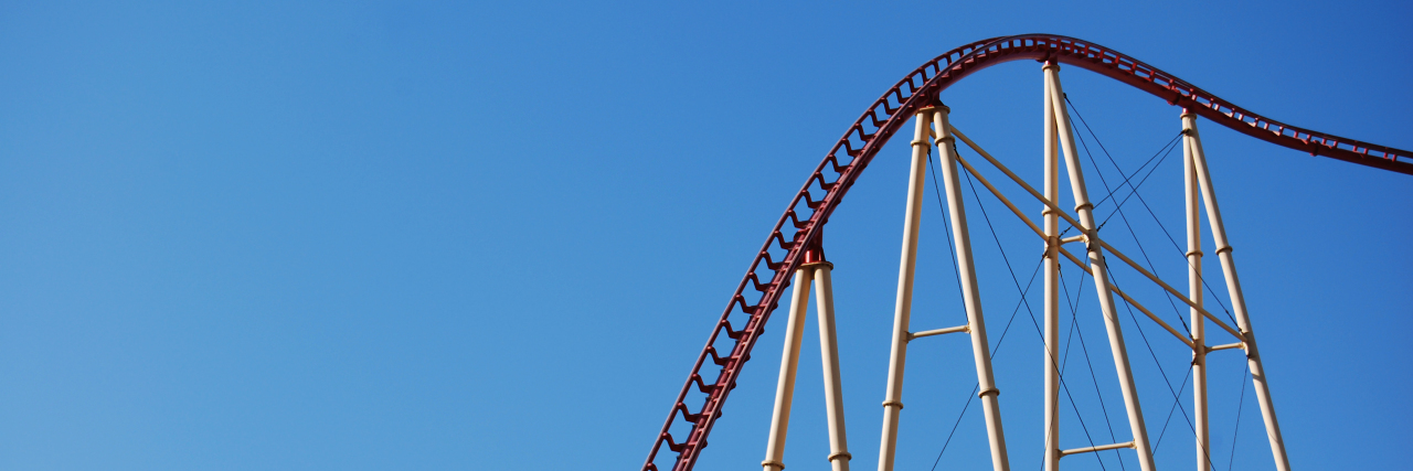a rollercoaster against a blue sky