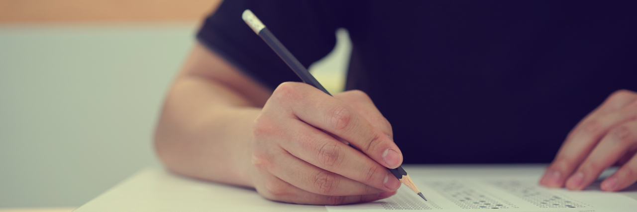 ACT to Pay Millions After Revealing College Students' Disabilities Someone bubbling multiple choice answers in